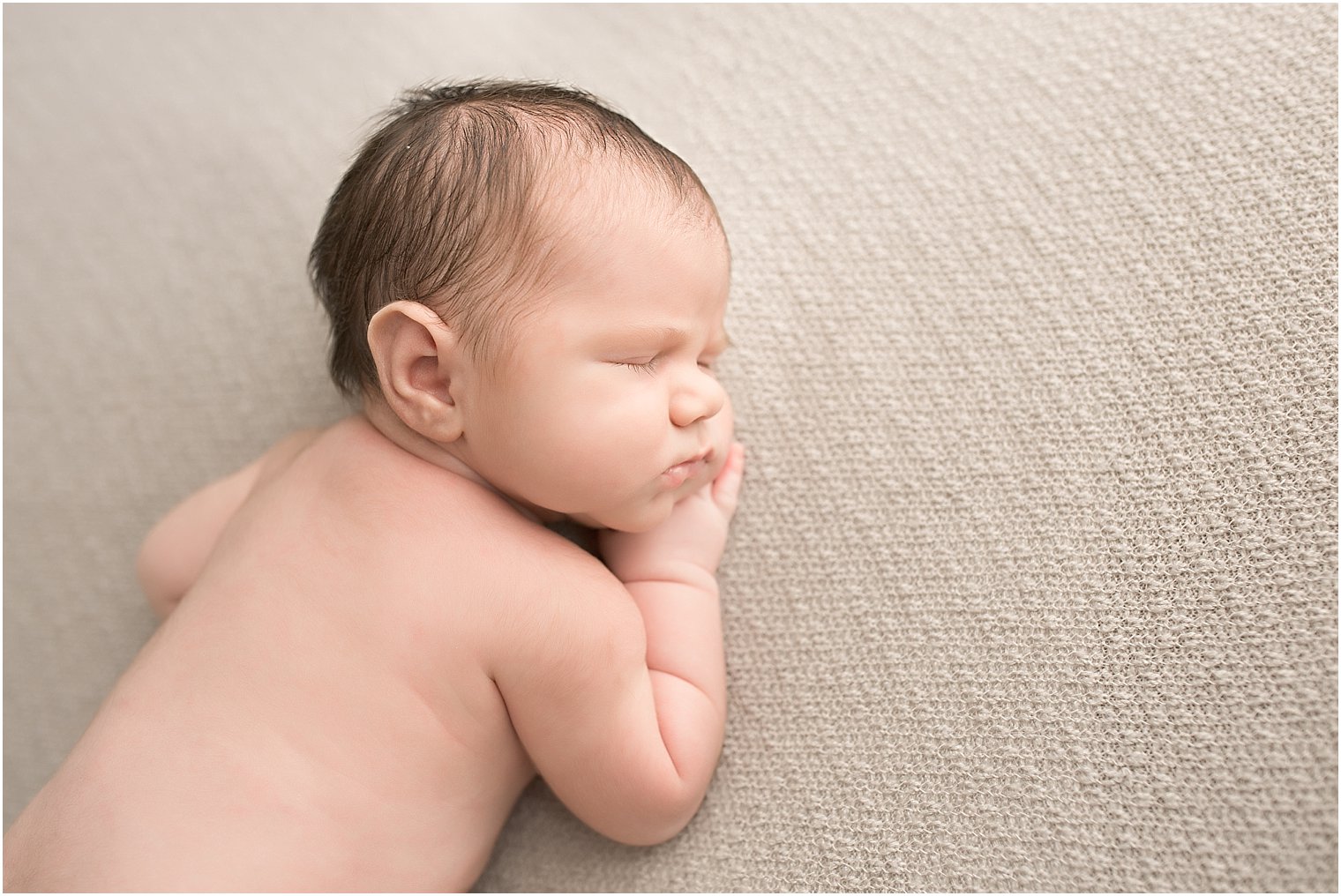 Newborn boy sleeping during newborn session