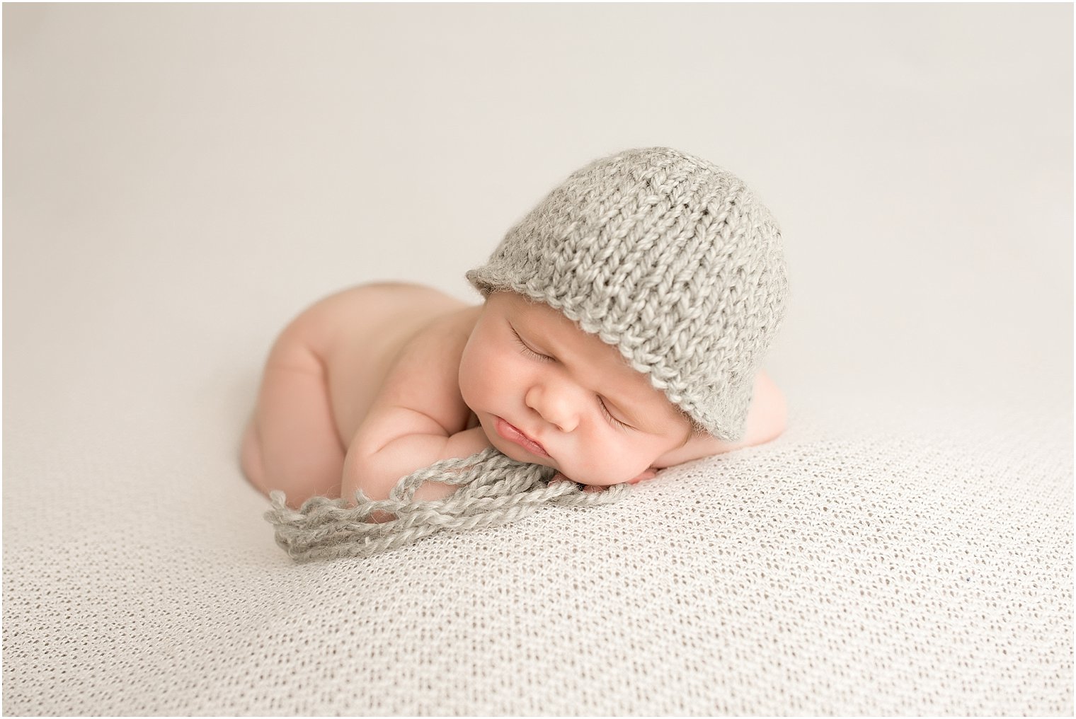 Newborn boy with gray hat