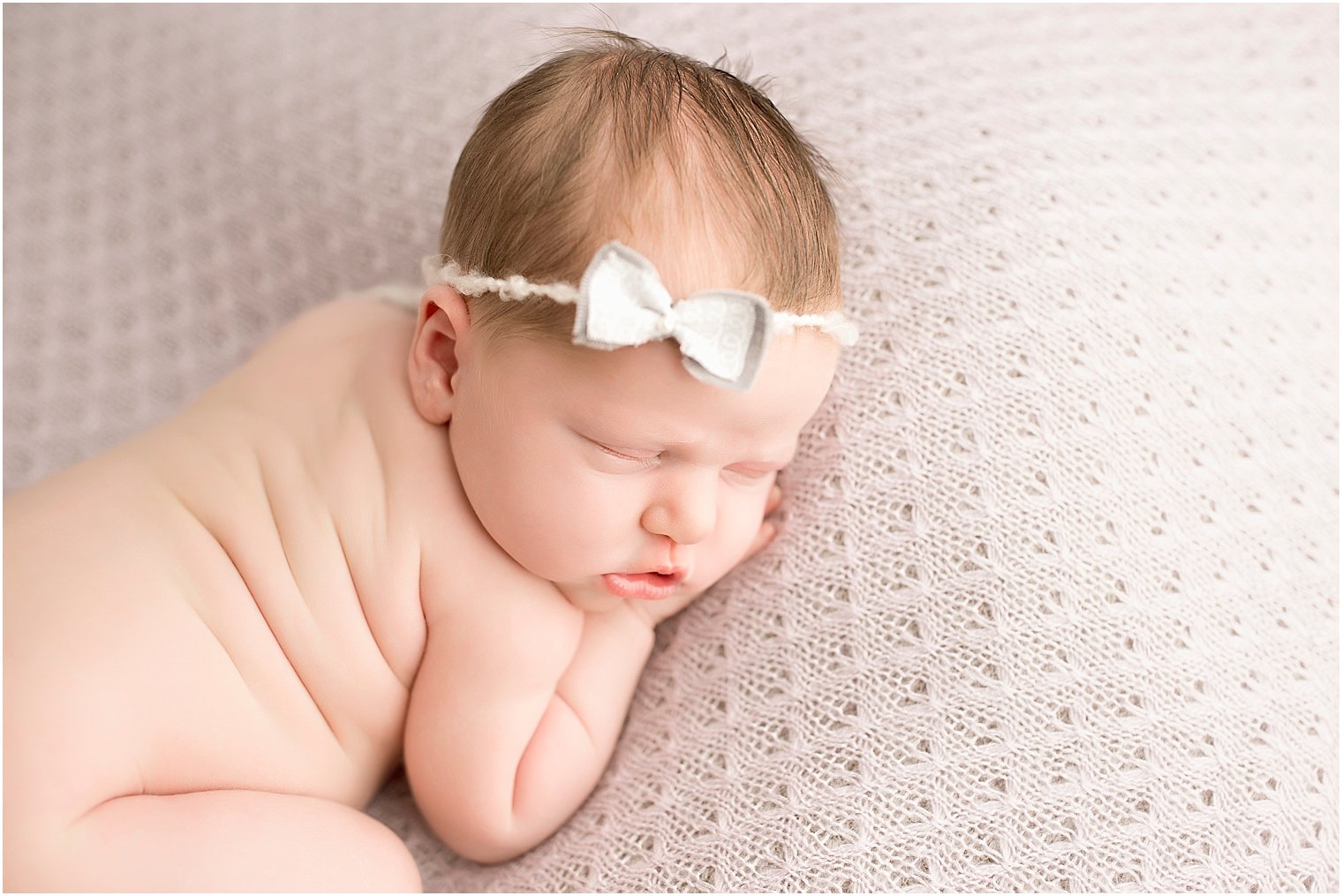 Baby girl on purple blanket