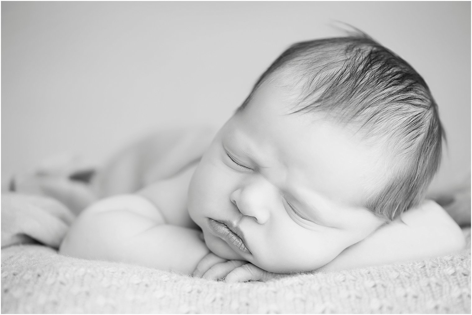 Black and white photo of newborn girl