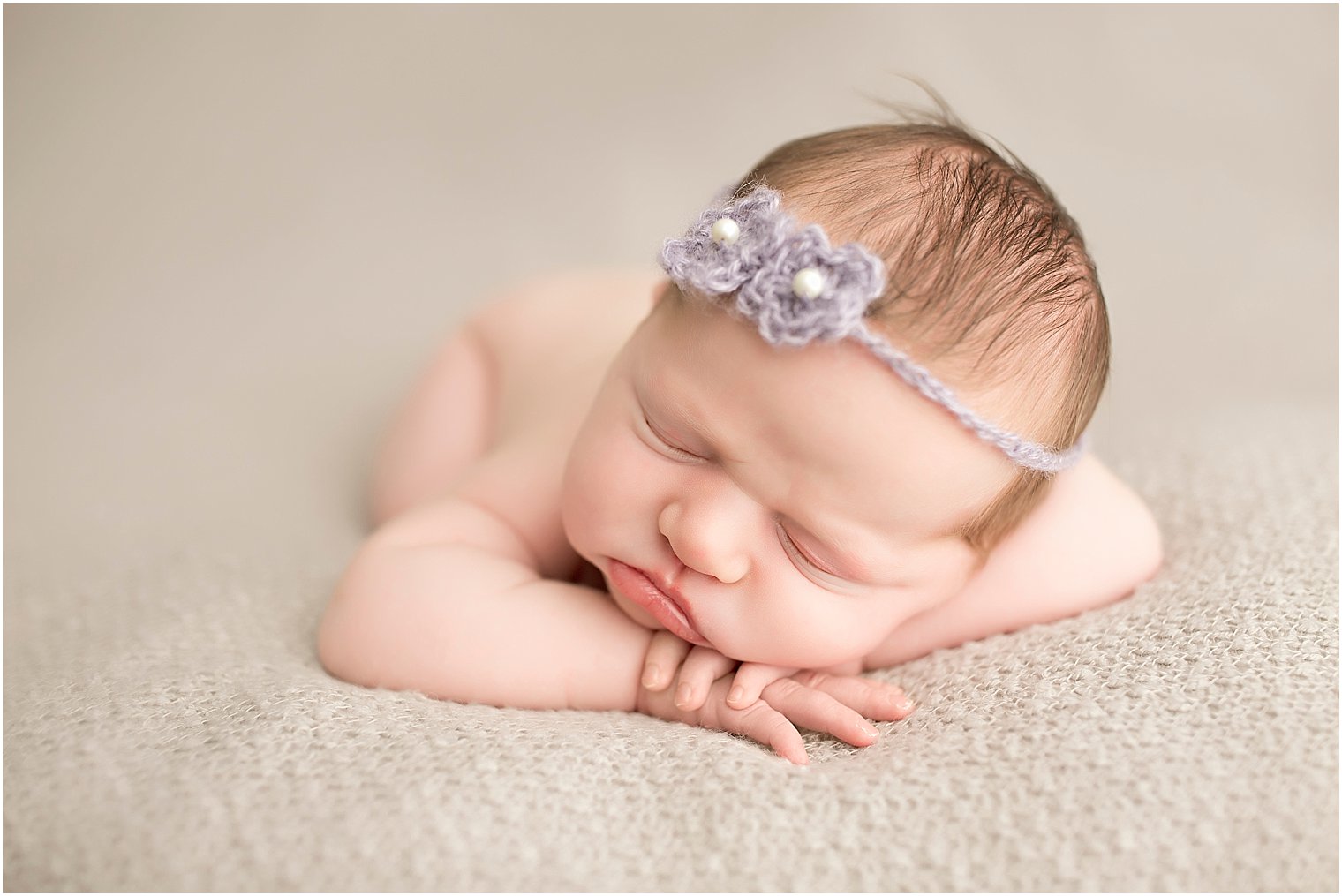 Newborn girl in purple headband