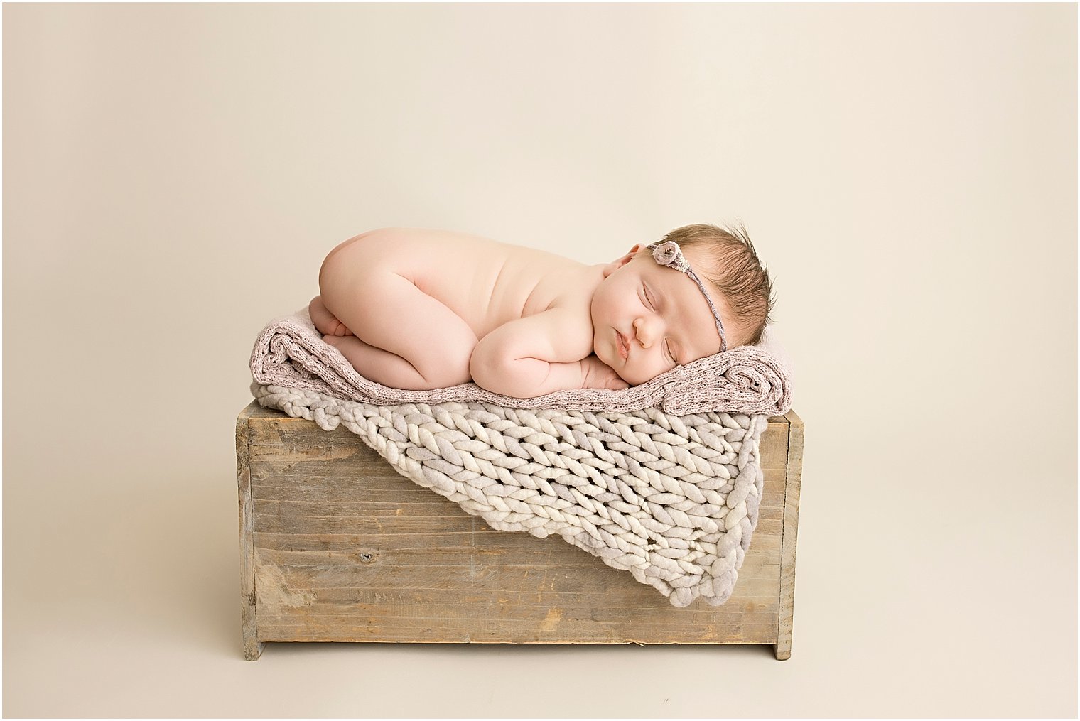Newborn baby on crate