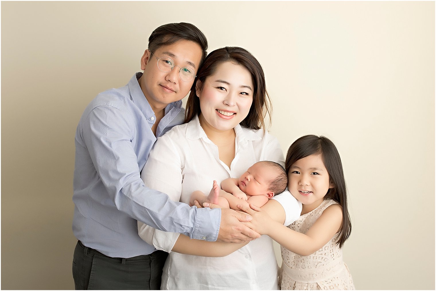 Portrait session of family of 4 with newborn baby