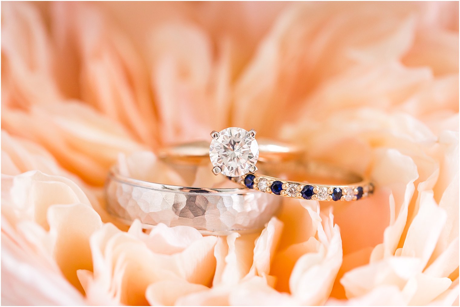 Wedding rings in peach flower; wedding band with blue sapphire