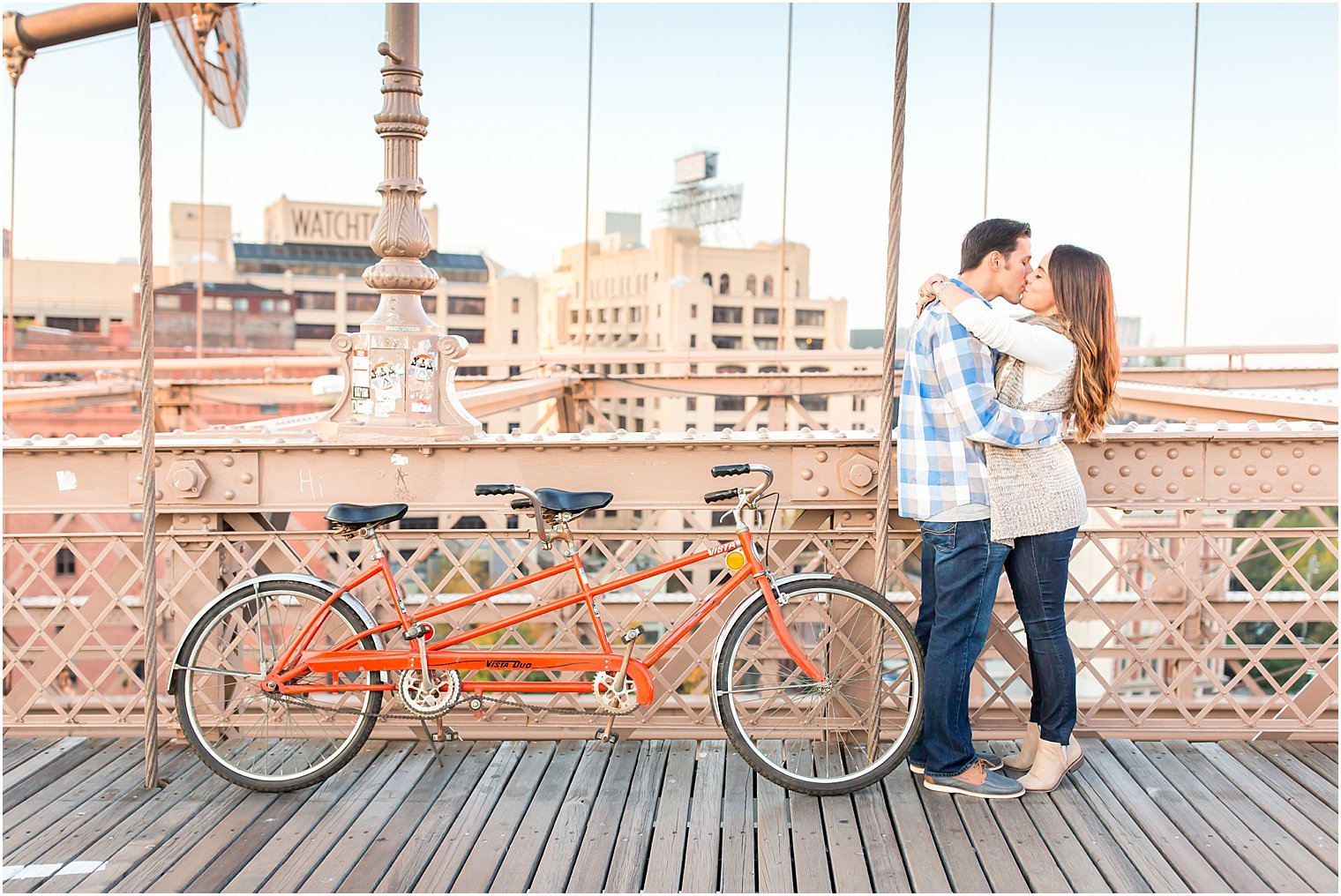 Couple kissing on the Brooklyn Bridge