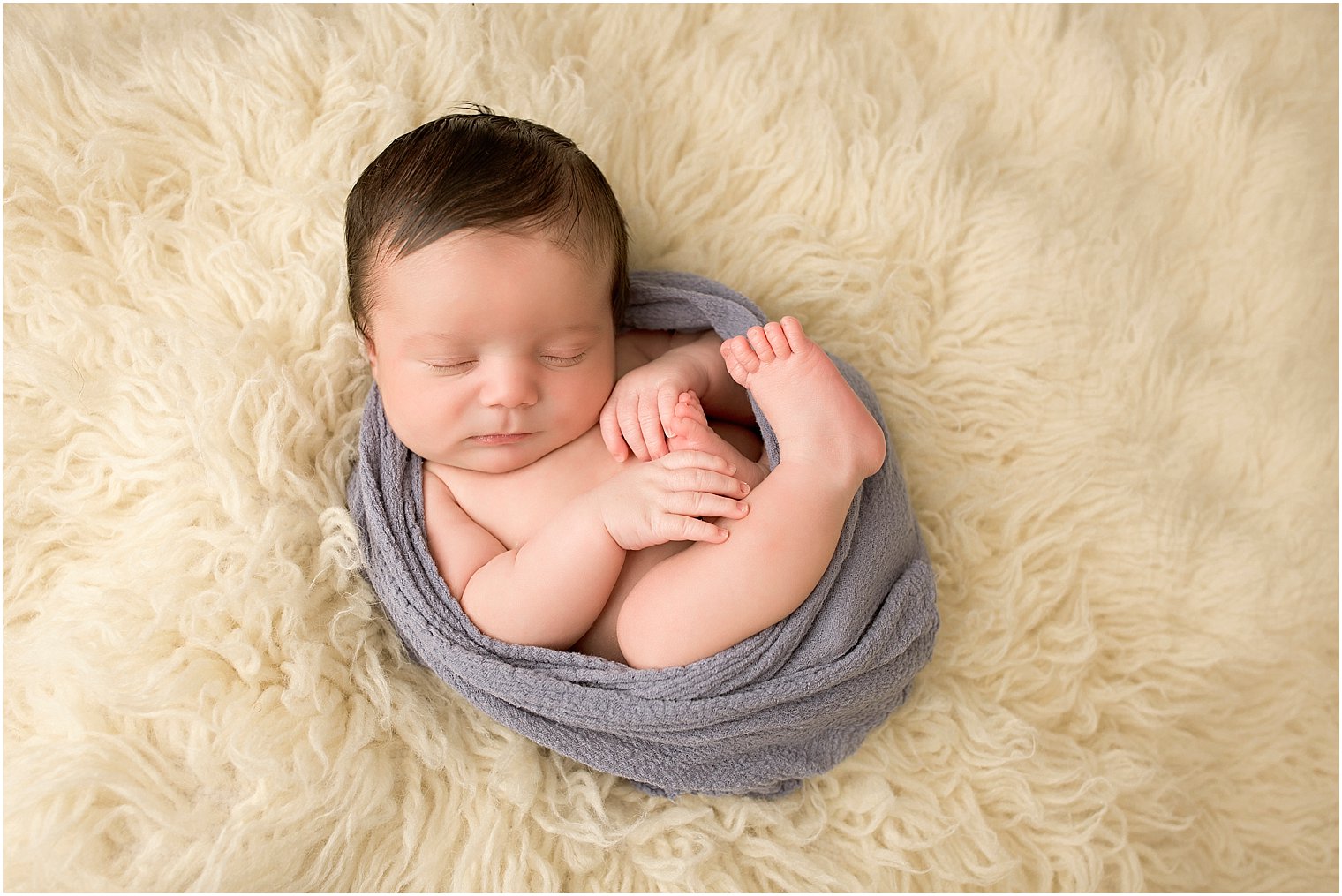 Newborn boy on flokati fur