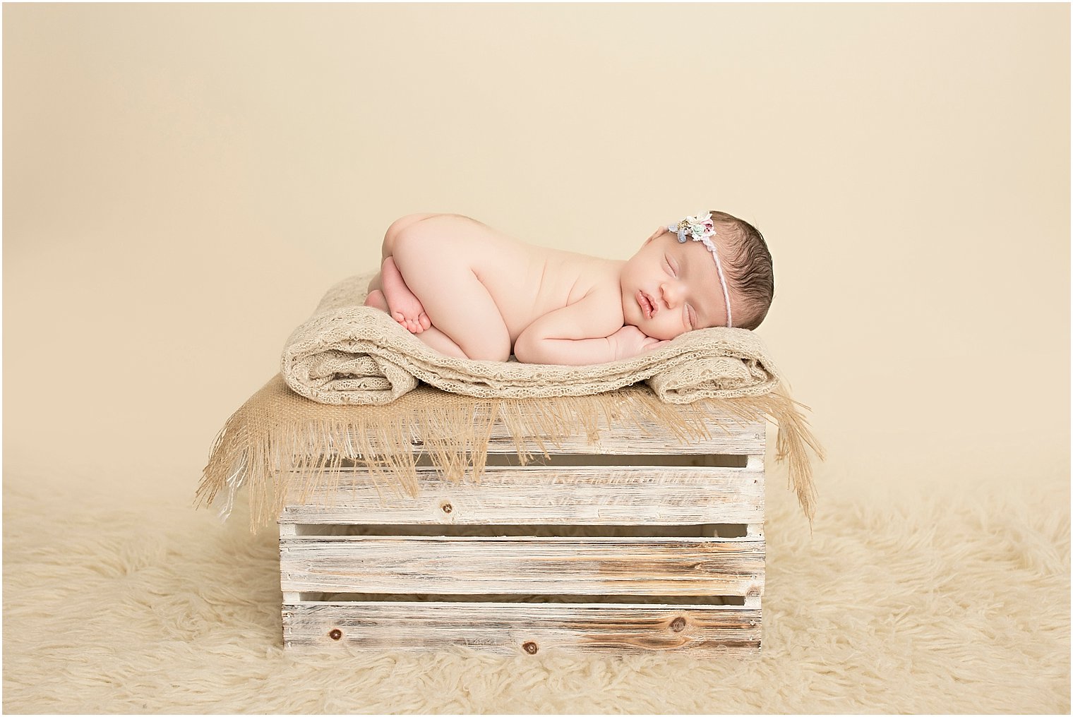 Sleeping newborn baby girl during neutrals session