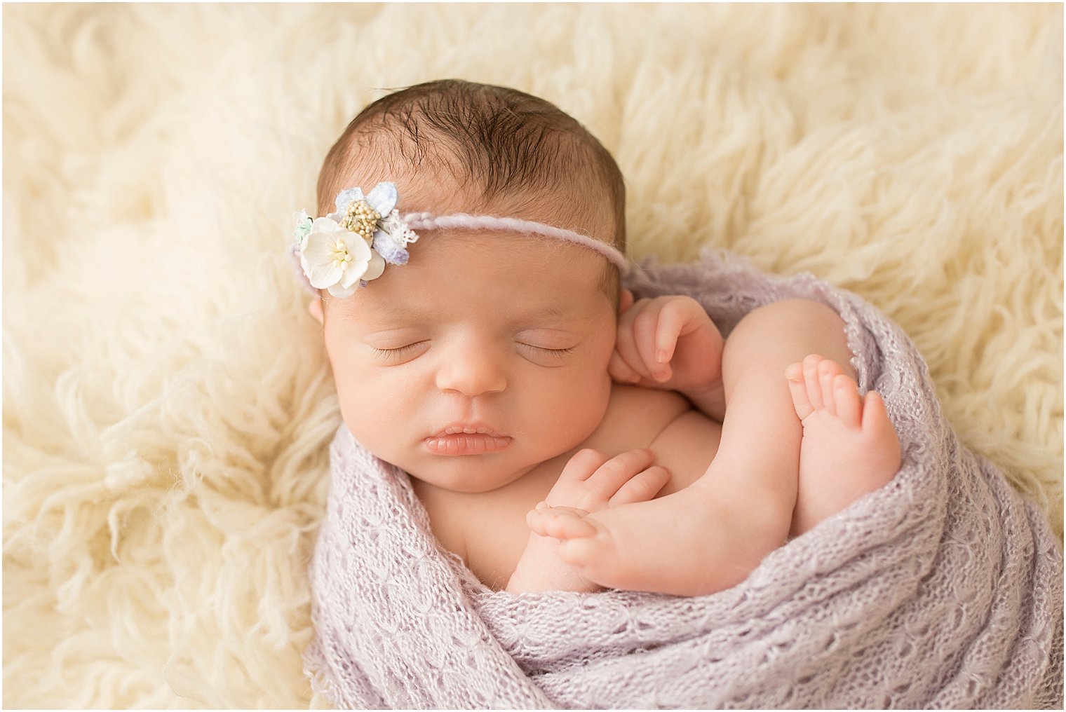 Newborn girl in lavender and cream