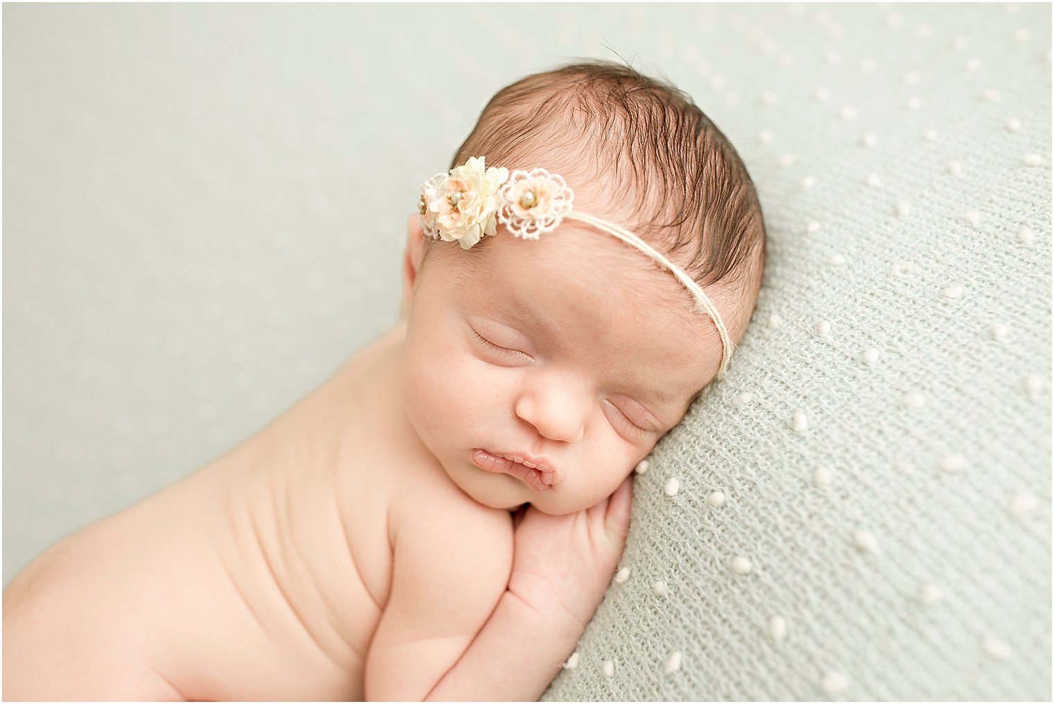 Sleepy girl on mint green blanket