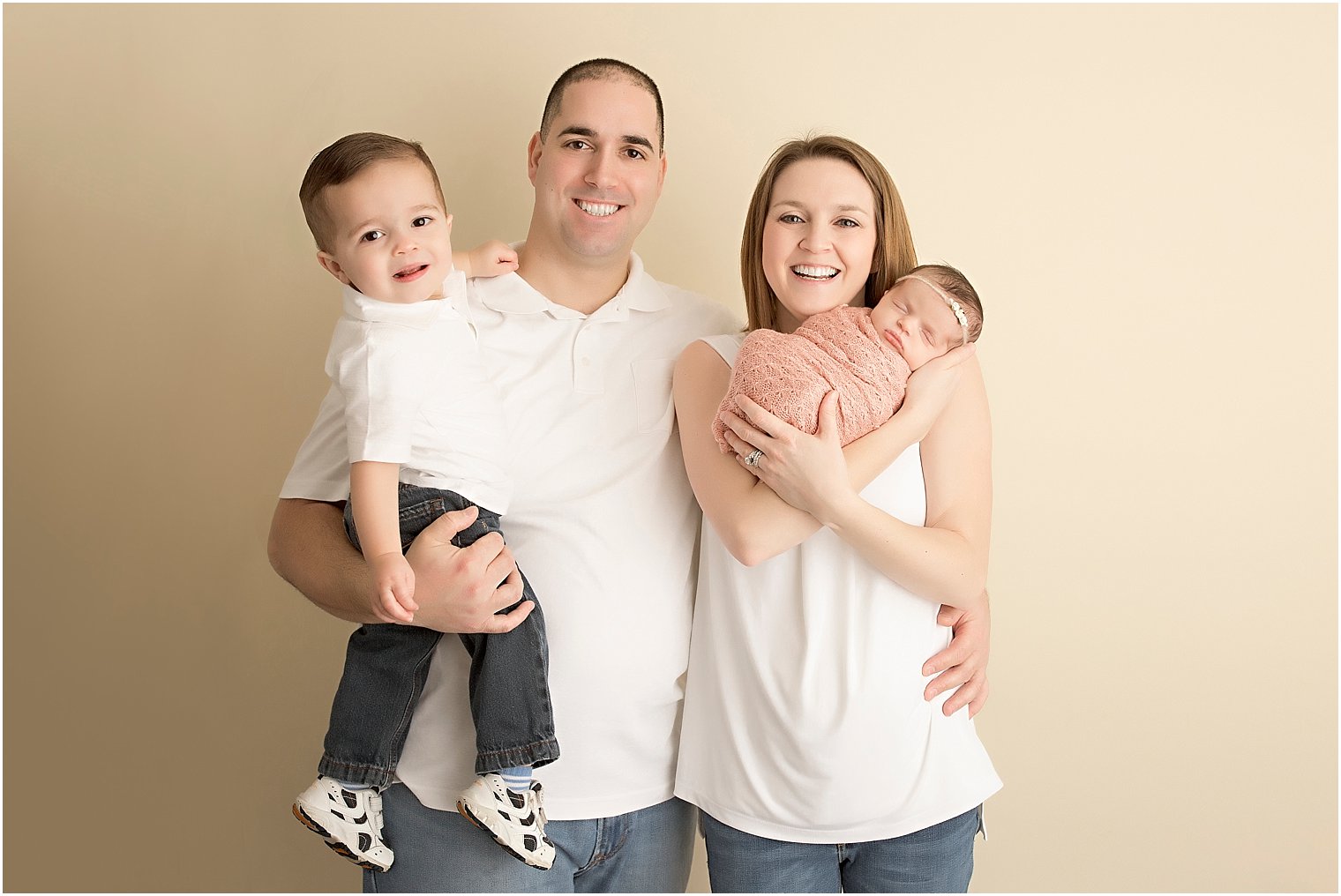 Family of four with newborn baby girl