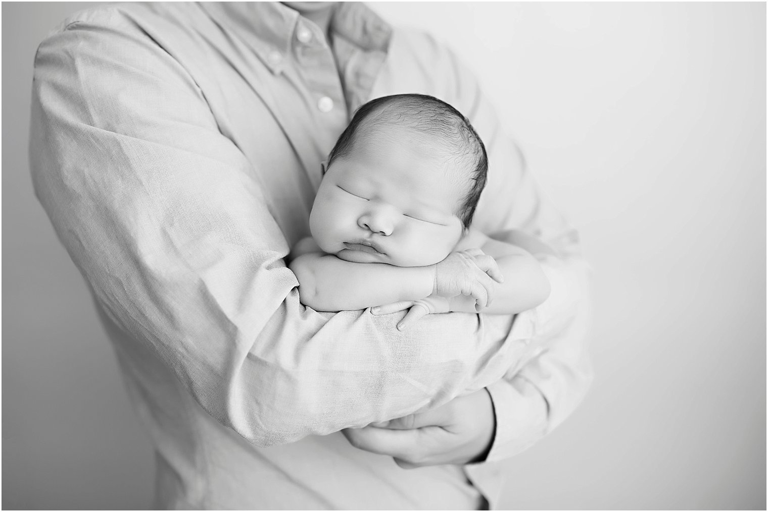 Newborn boy in father's arms