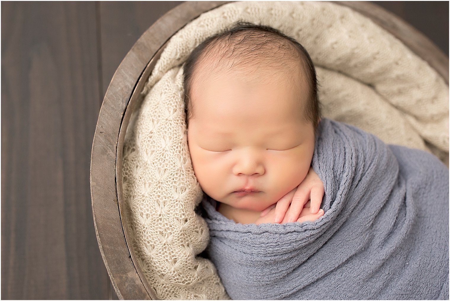 Newborn baby boy in blue and tan