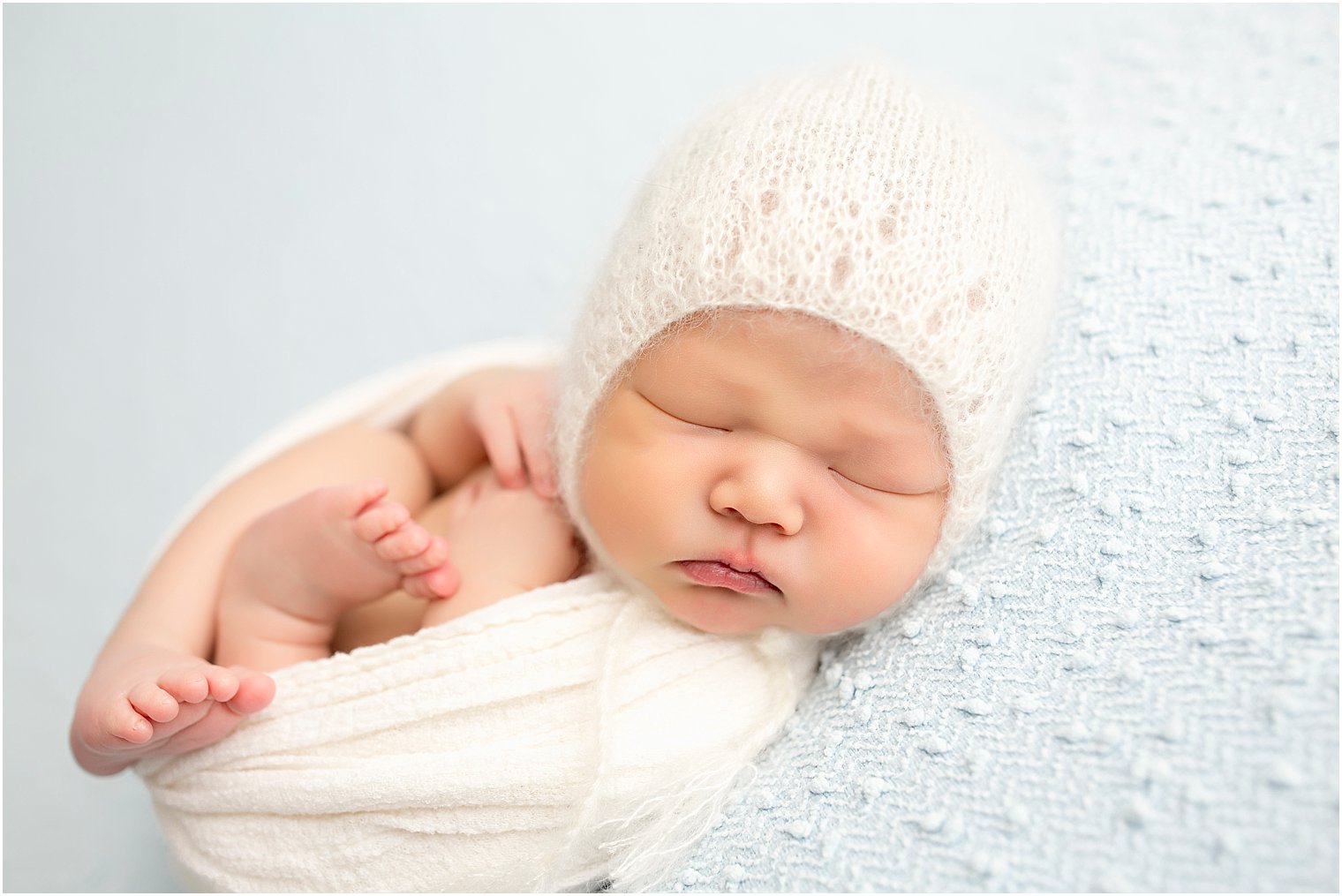 Sweet newborn boy in mohar hat