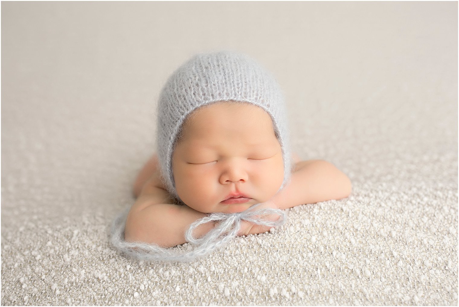 Beautiful little boy sleeping during his newborn session