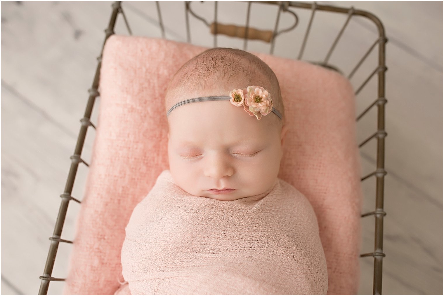 Newborn girl in pink and gray set-up