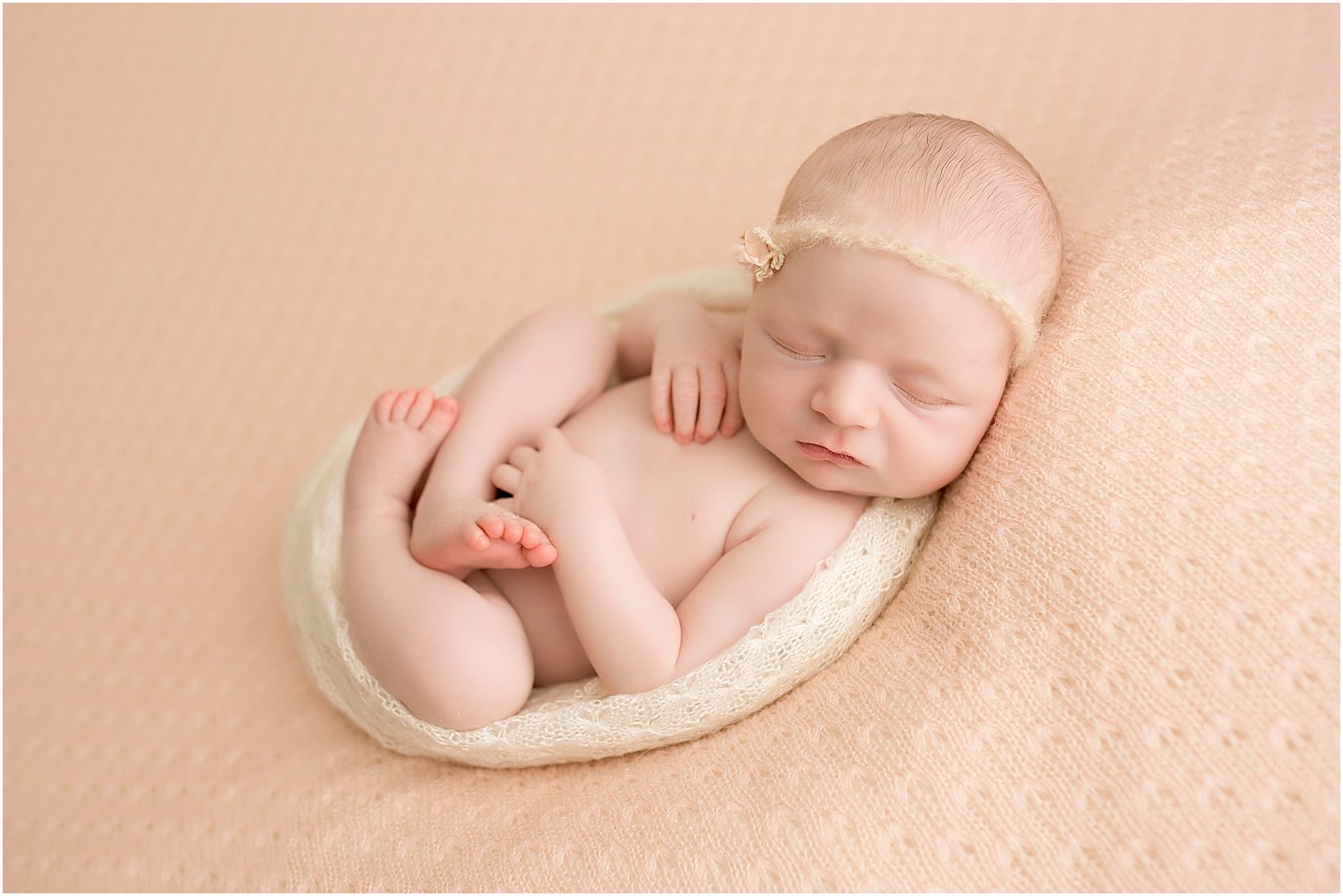 Newborn girl in Huck Finn pose