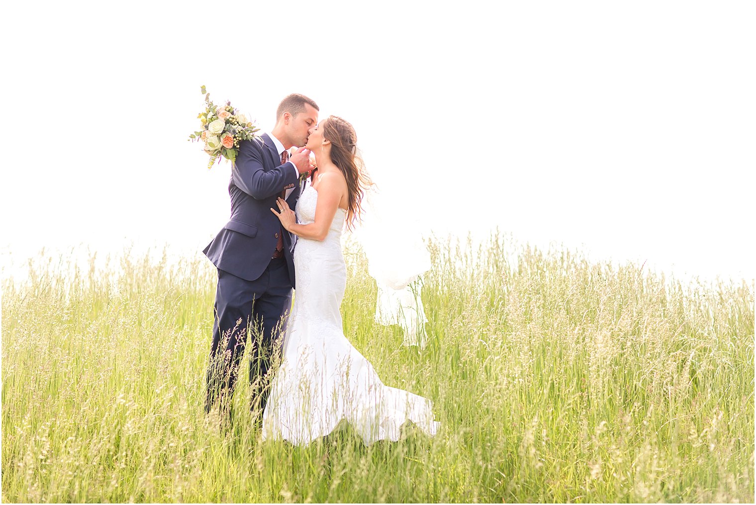 Romantic bride and groom in a field | Photo by Idalia Photography