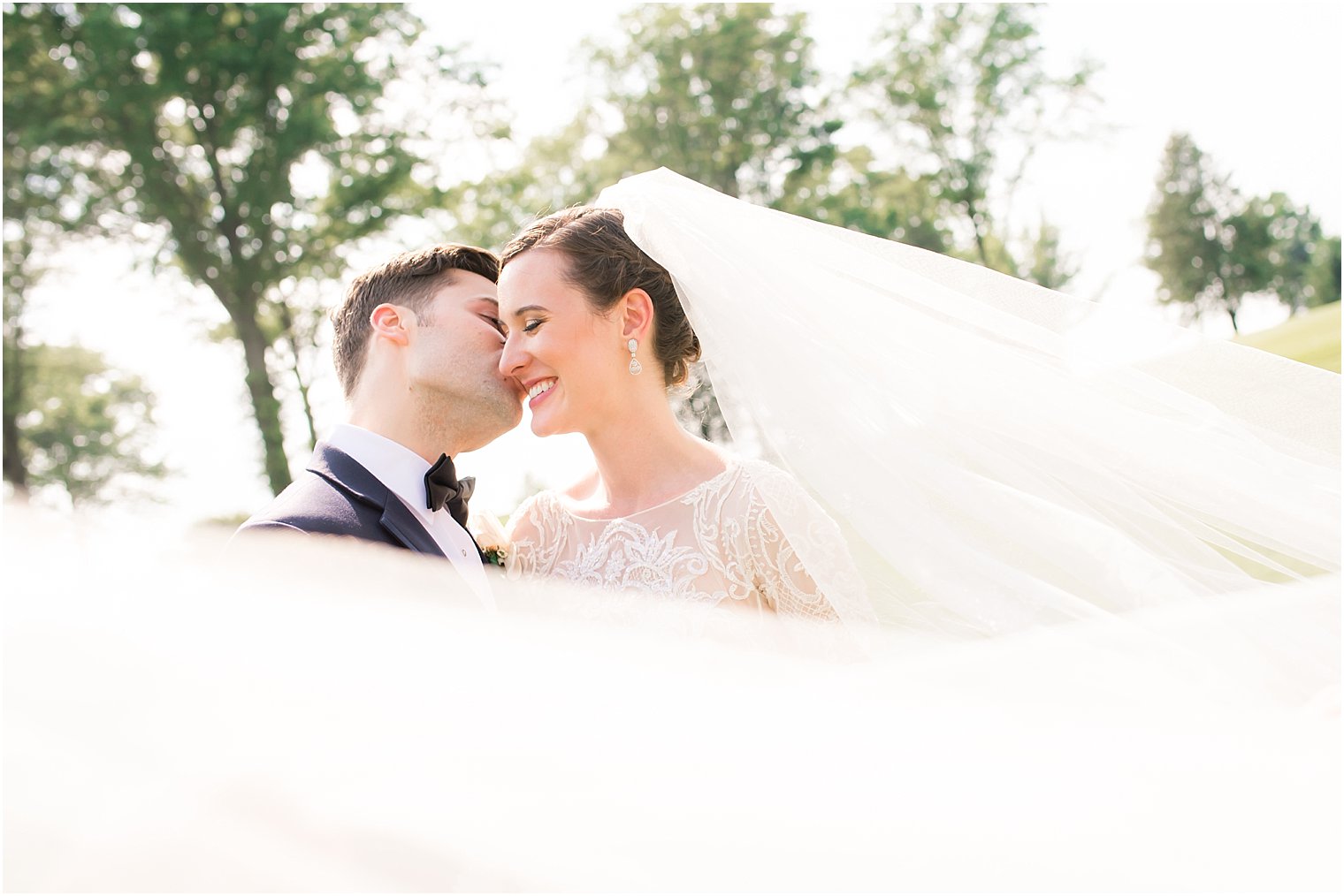 Bride and groom veil shot | Photo by Idalia Photography