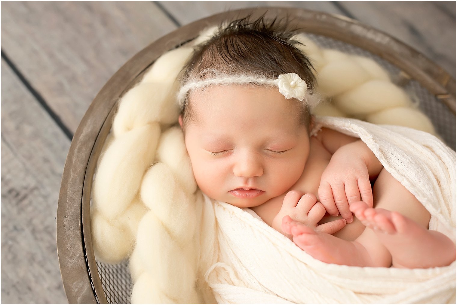 Newborn girl in a wooden basket