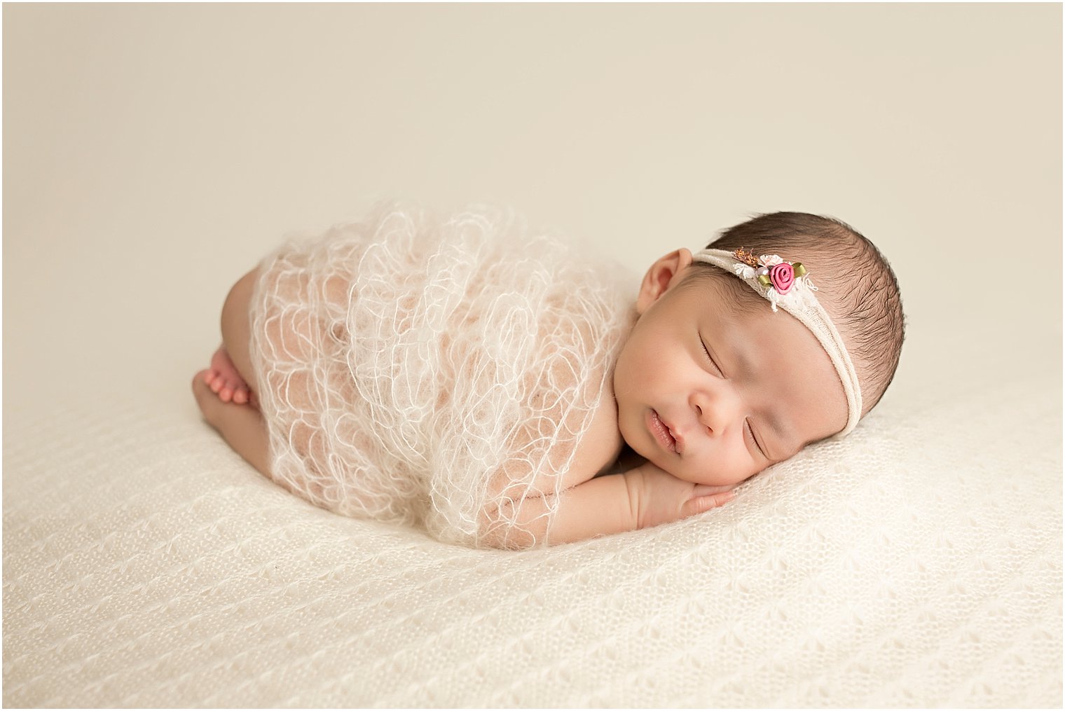 Newborn girl tushie up with cream wrap