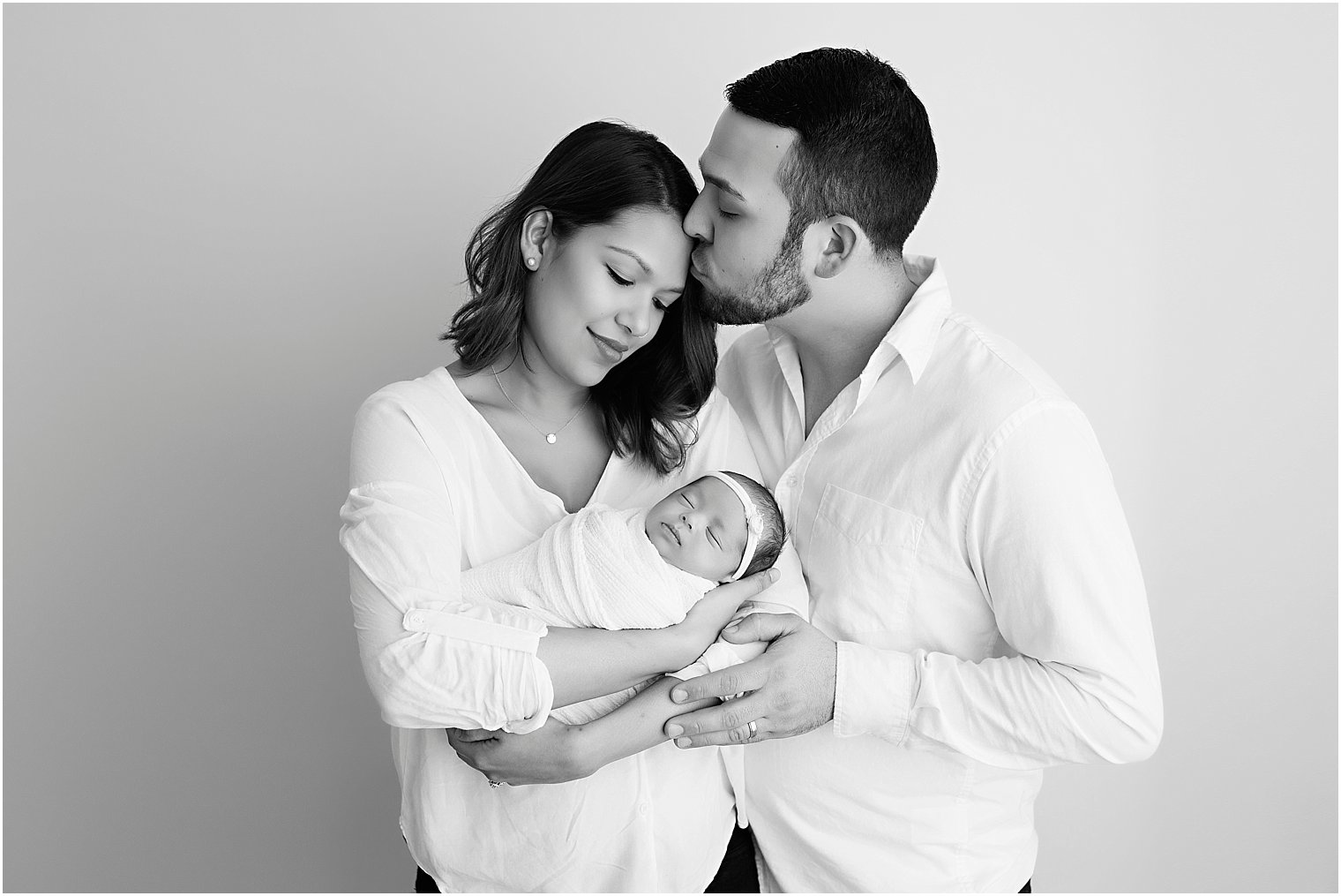 Classic black and white image of family and newborns