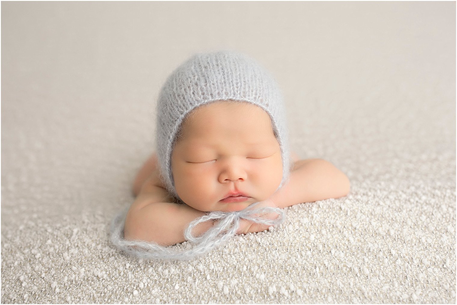 Newborn boy in knit mohair hat by Blueberry Props