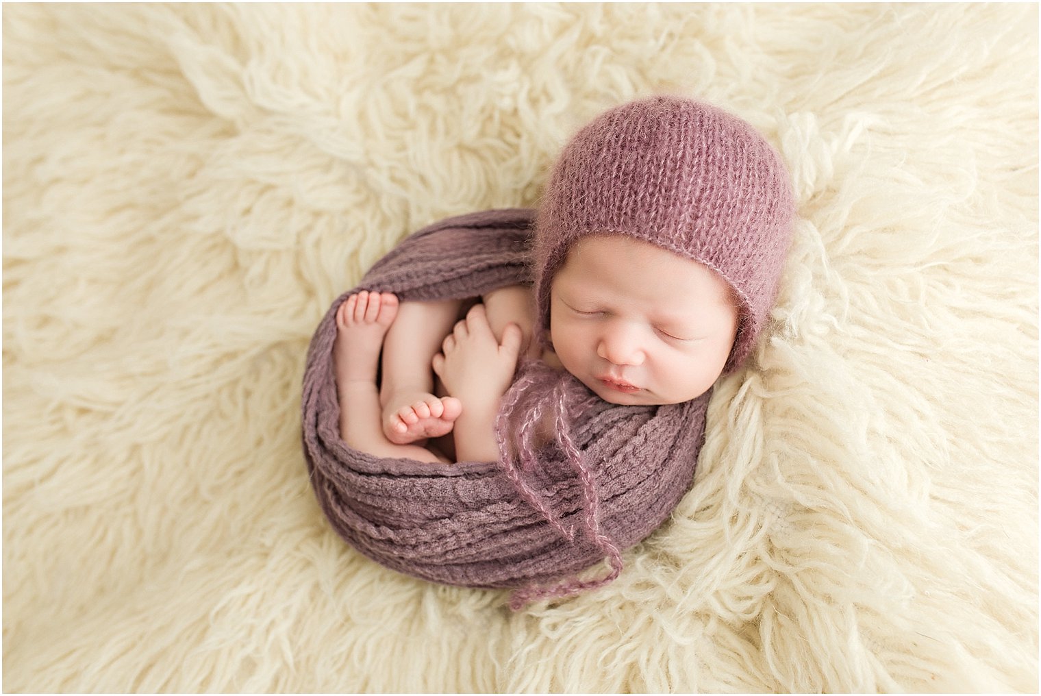Baby girl in purple newborn mohair bonnet