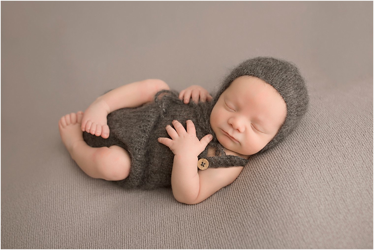 Newborn boy in knit romper