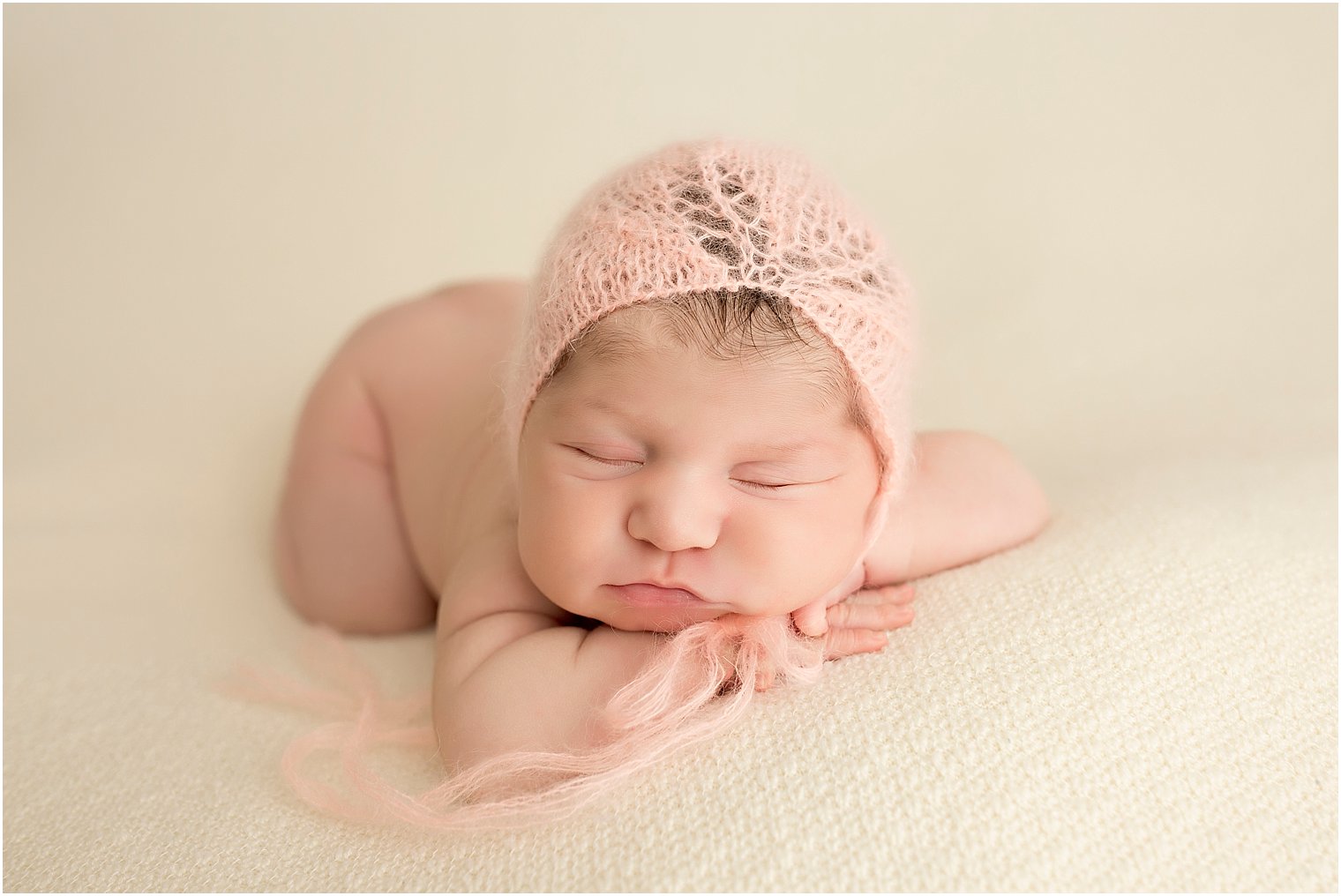 Newborn baby girl wearing peach mohair hat