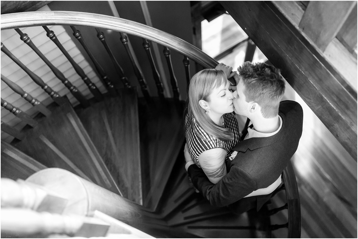 Couple kissing in spiral staircase