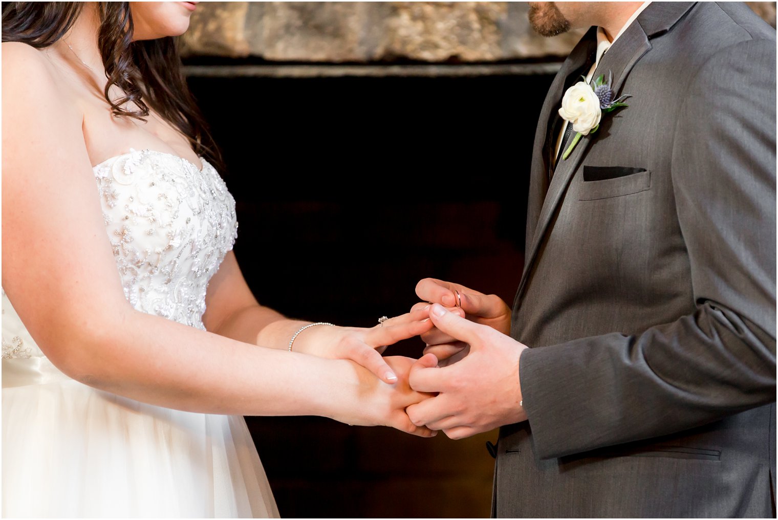 Ring exchange during indoor ceremony | Photo by Idalia Photography