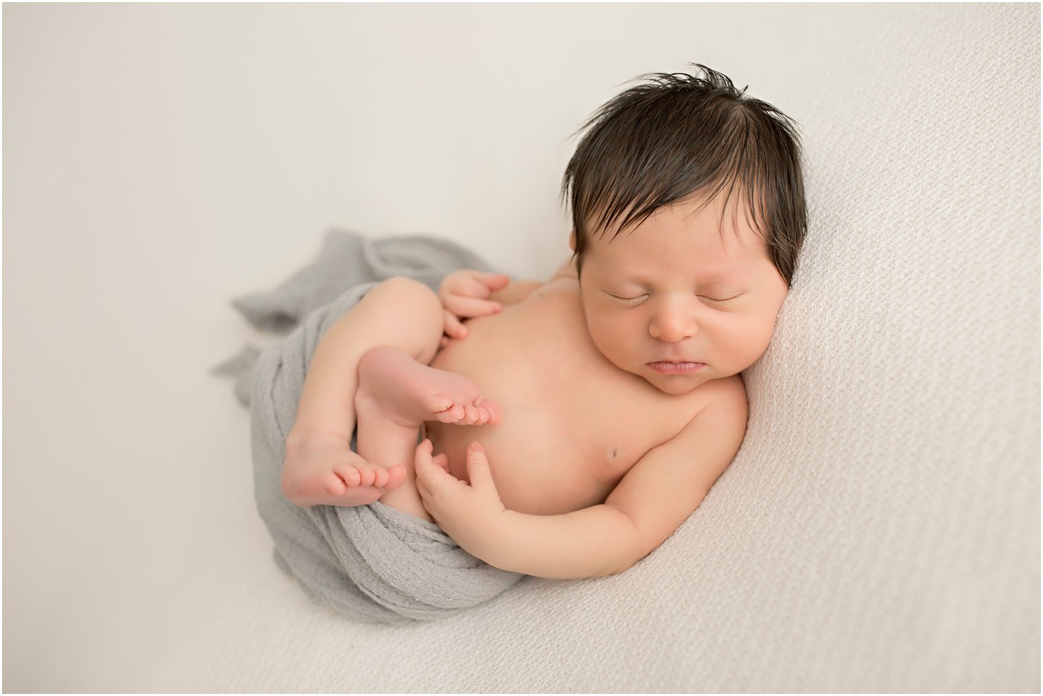 Newborn boy in Huck Finn Pose