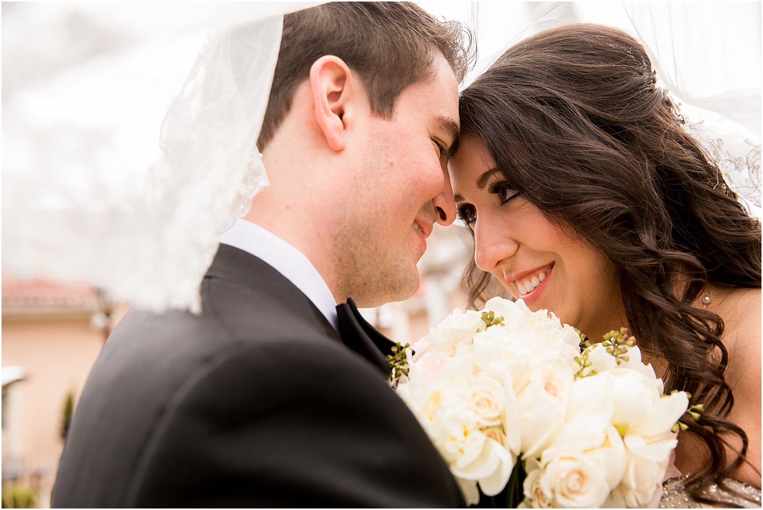 Sweet couple photo under the veil | Photo by Idalia Photography