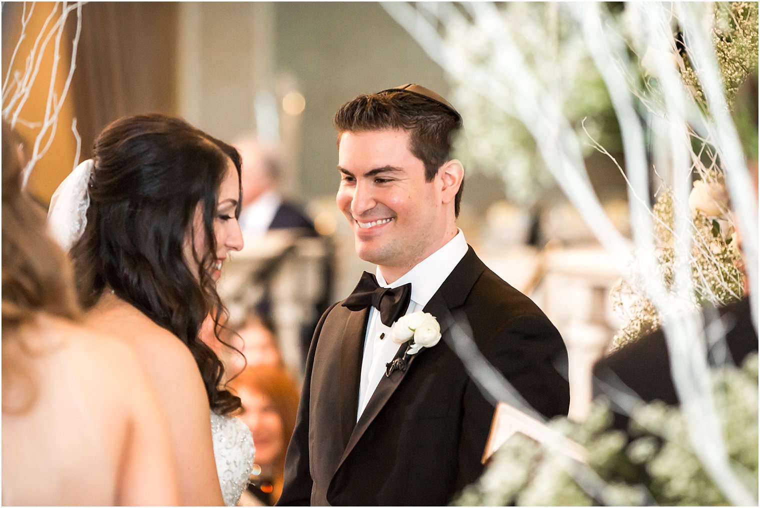 Groom admiring his bride during wedding ceremony | Photo by Idalia Photography