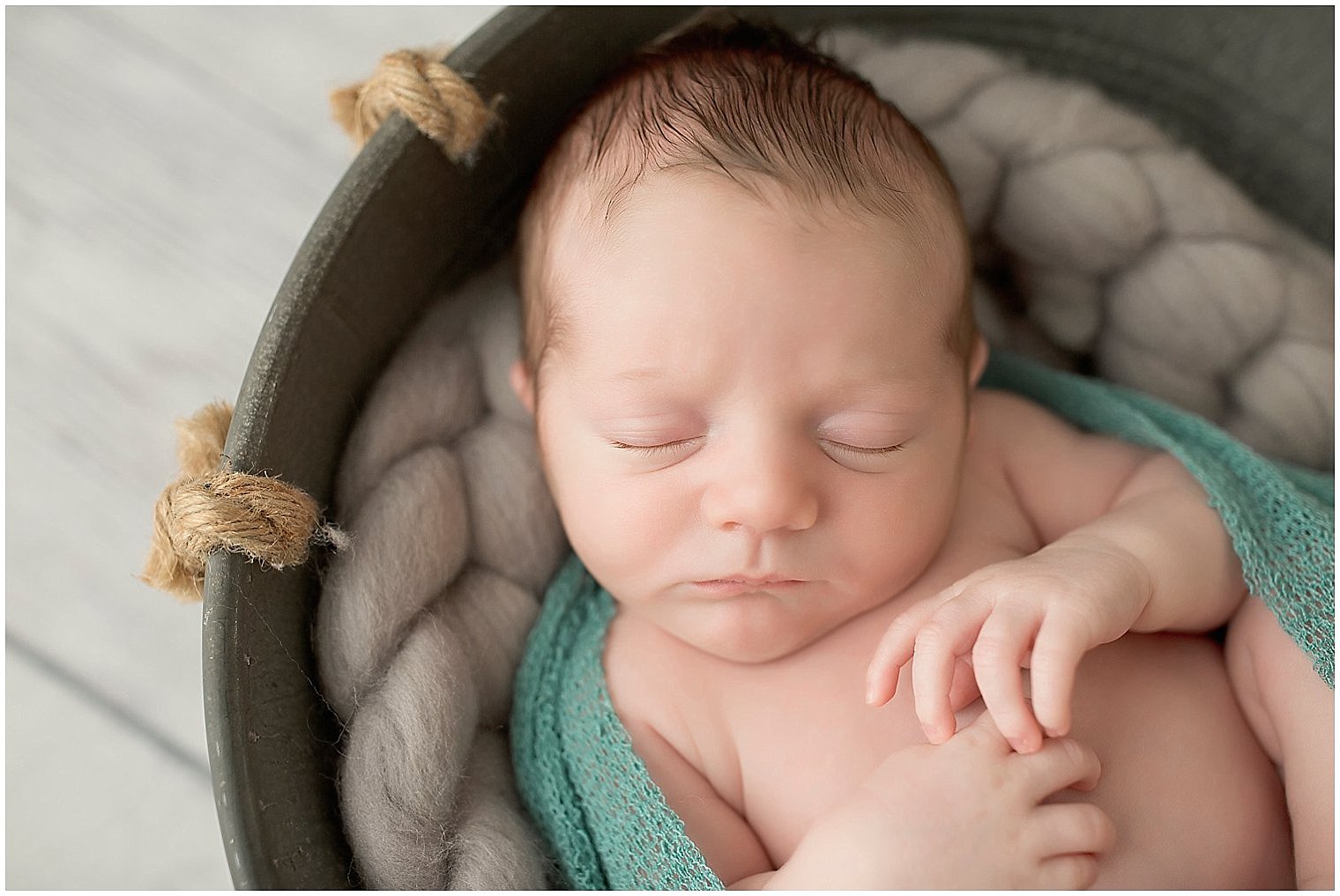 Newborn boy in a bucket | Photo by Idalia Photography