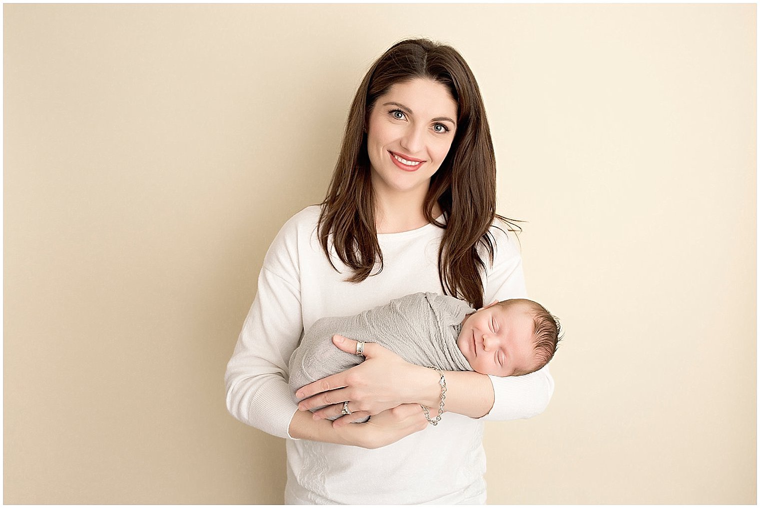 Happy newborn in mama's arms | Photo by Idalia Photography