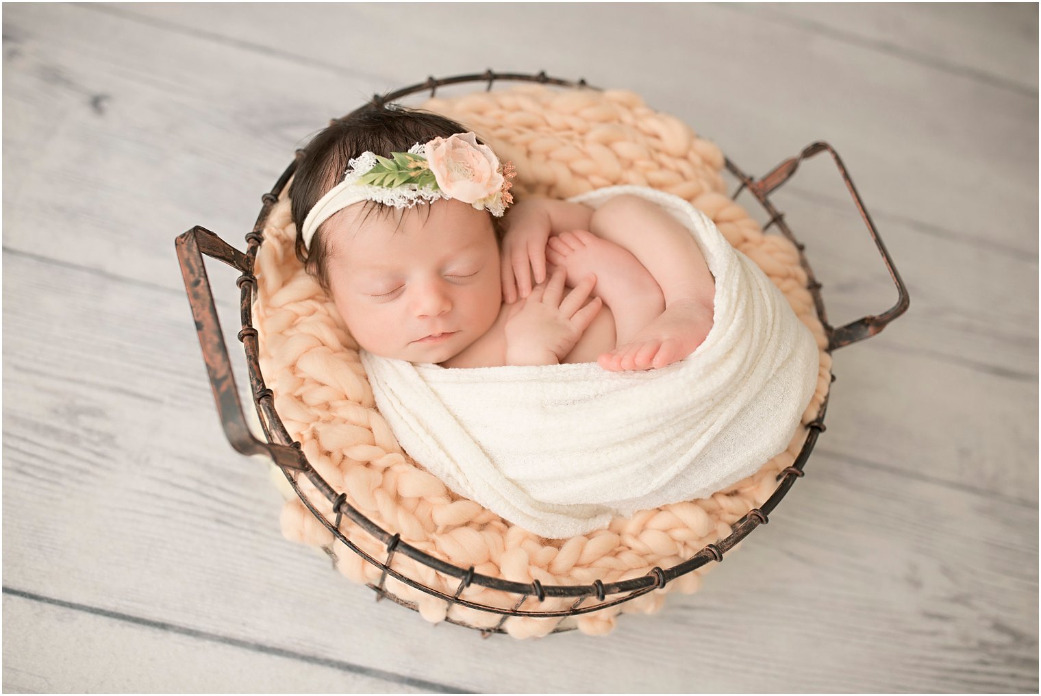 Newborn curled in basket | Photos by Idalia Photography