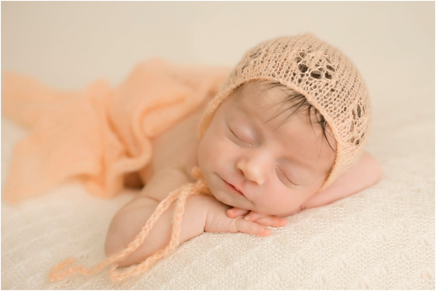 Newborn in peach crochet bonnet and wrap | Photos by Idalia Photography