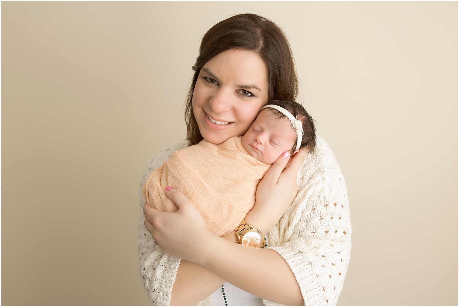 Newborn girl in peach wrap with mother | Photos by Idalia Photography