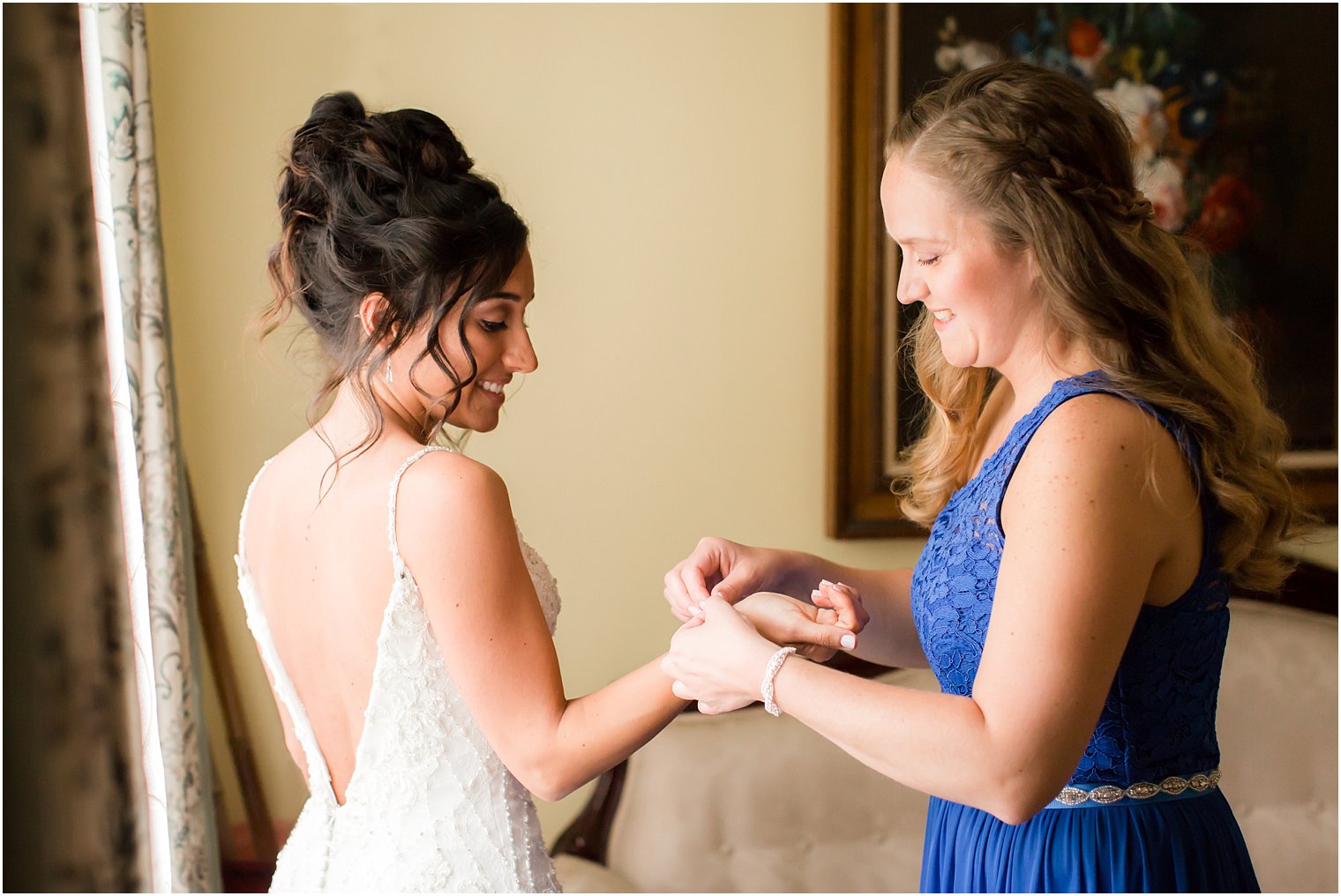 Bride getting ready with maid of honor
