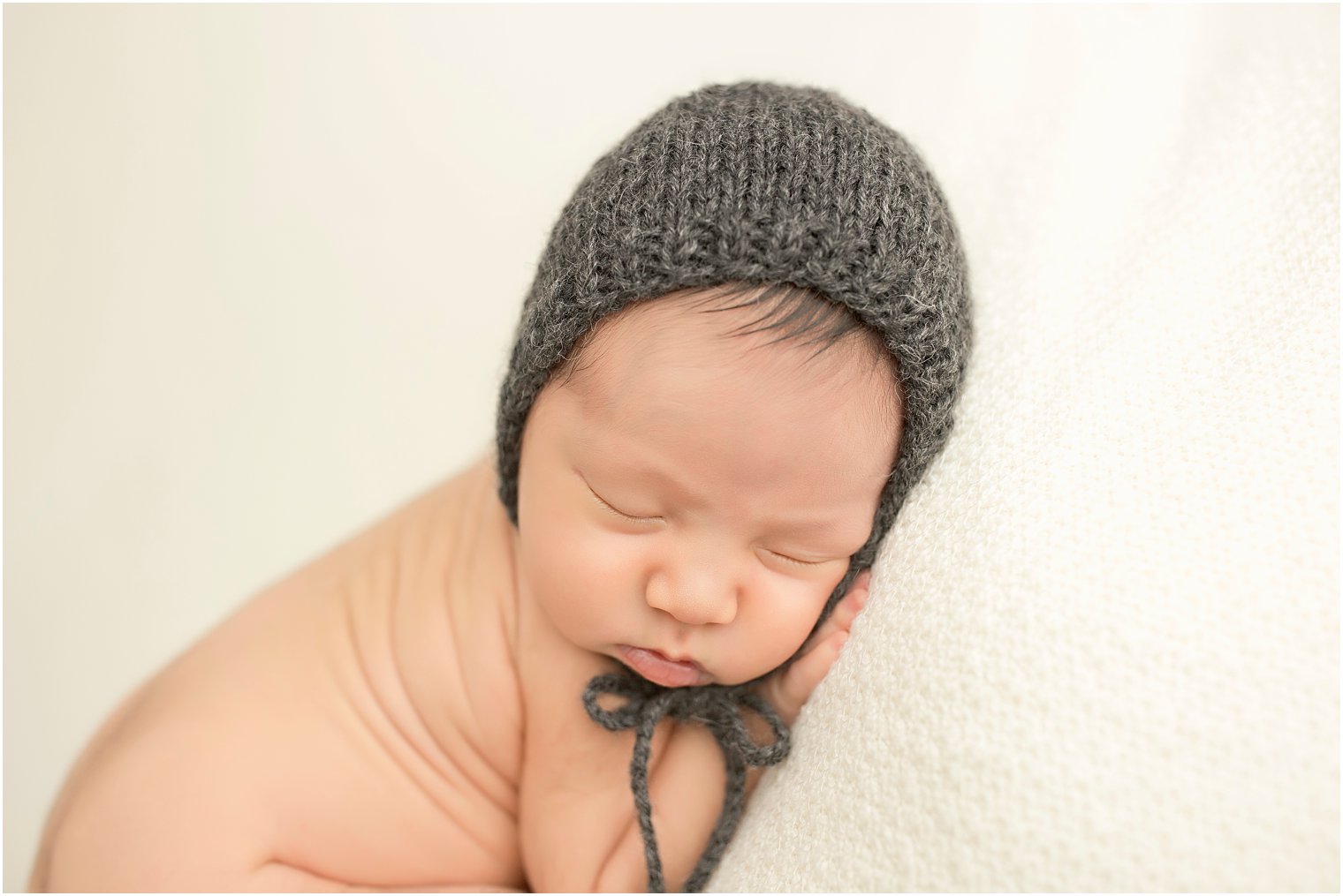 Newborn boy with gray hat