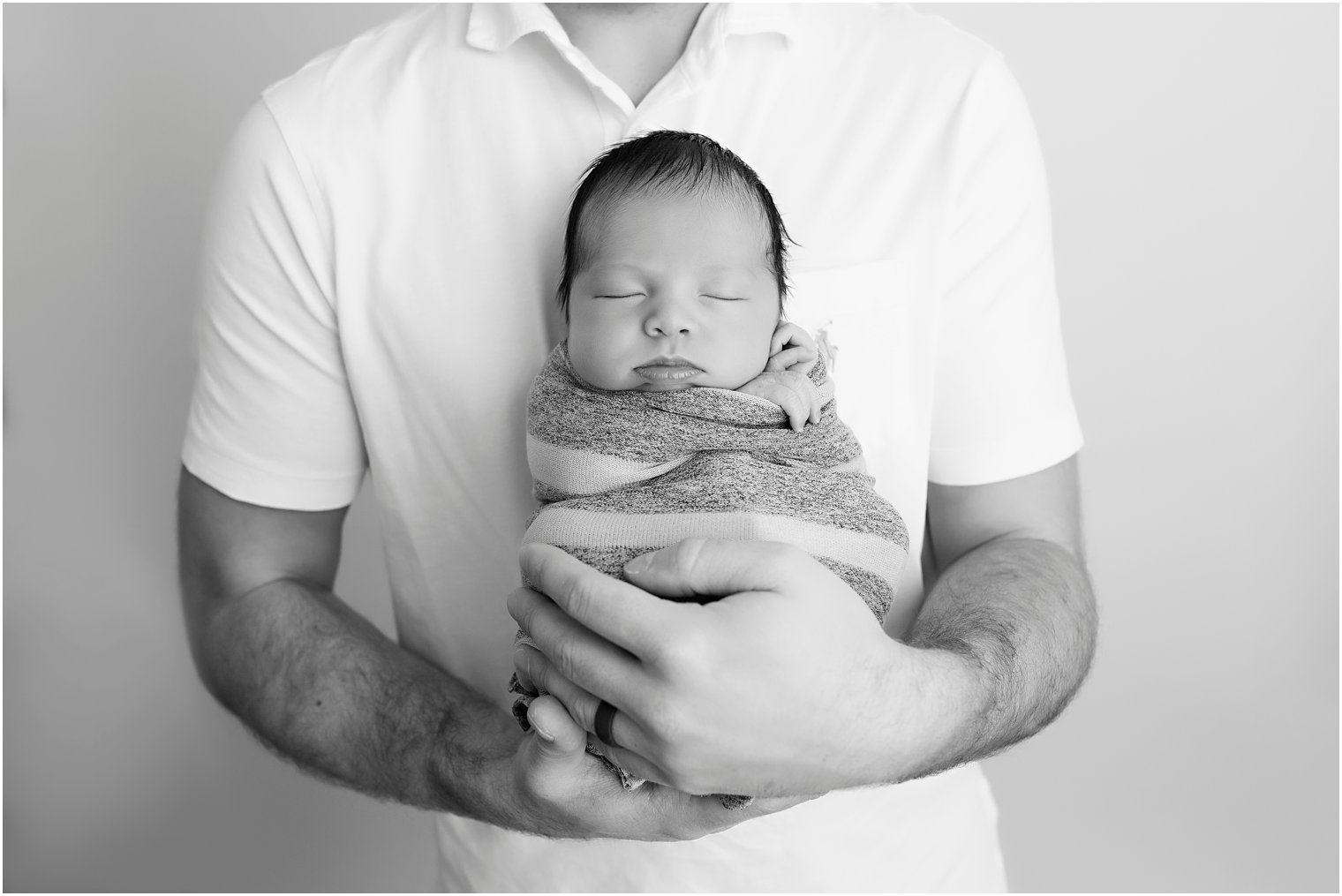 Newborn boy in daddy's arms