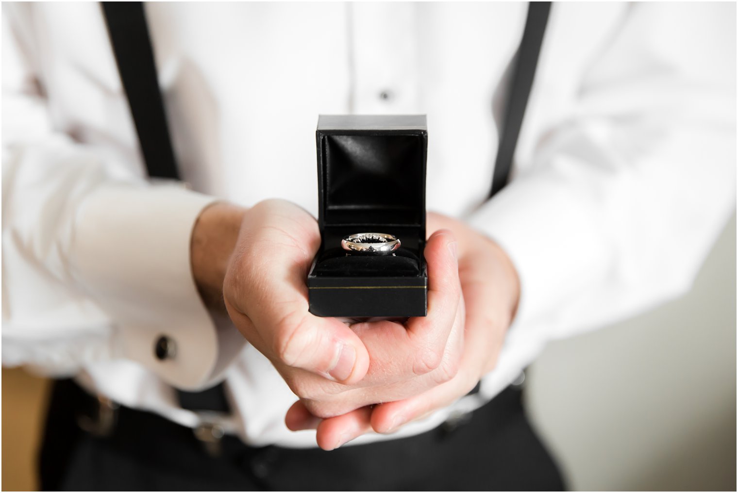 Best man holding wedding bands | Photos by Idalia Photography