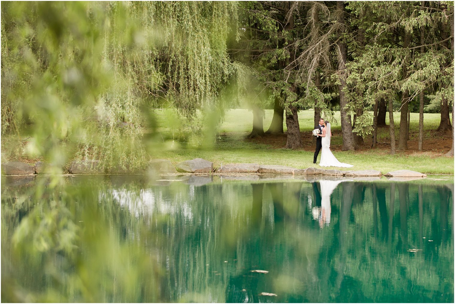 Bride and groom among weeping willow trees | Photos by Idalia Photography
