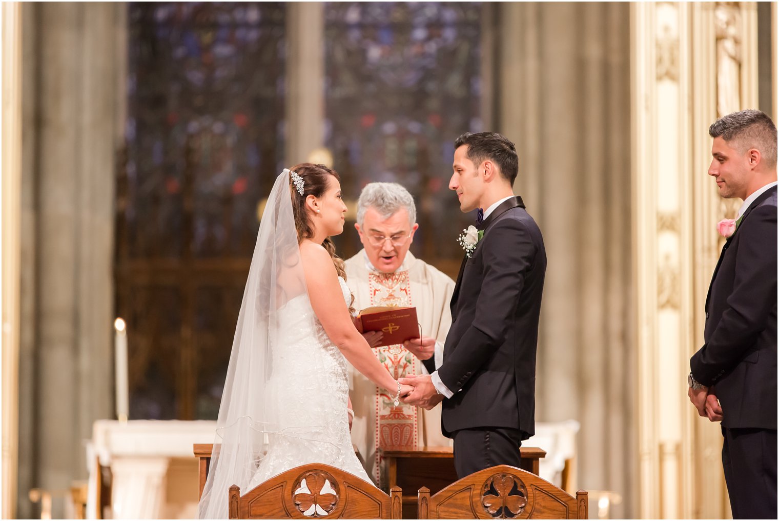 Bride and groom exchange of vows at St. Patrick's Cathedral | Photo by Idalia Photography