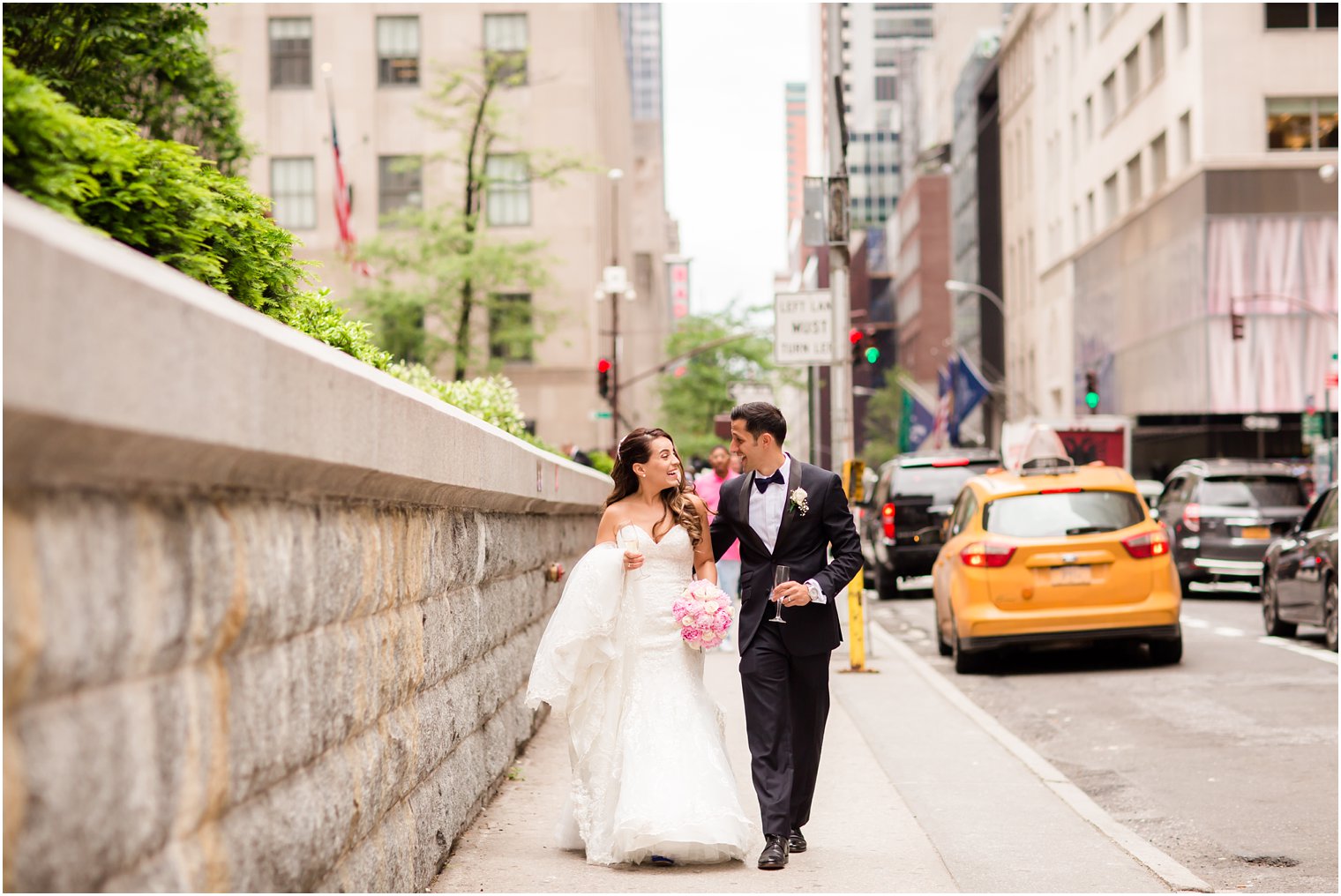 Couple walking through NYC streets on wedding day | Photo by Idalia Photography