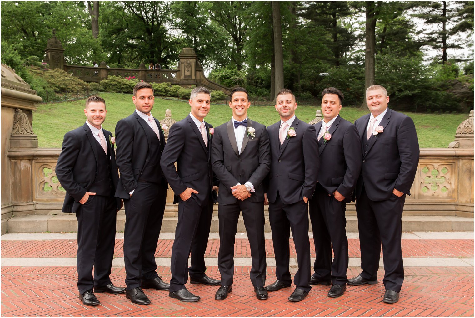 Groomsmen in navy suits and pink ties | Photo by Idalia Photography