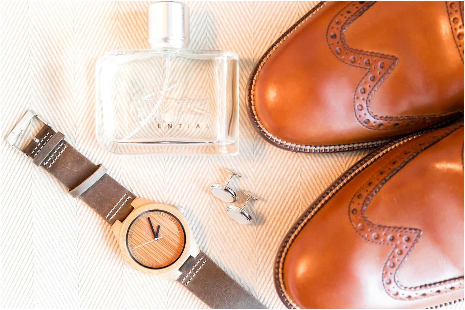 Groom's brown shoes and wooden watch