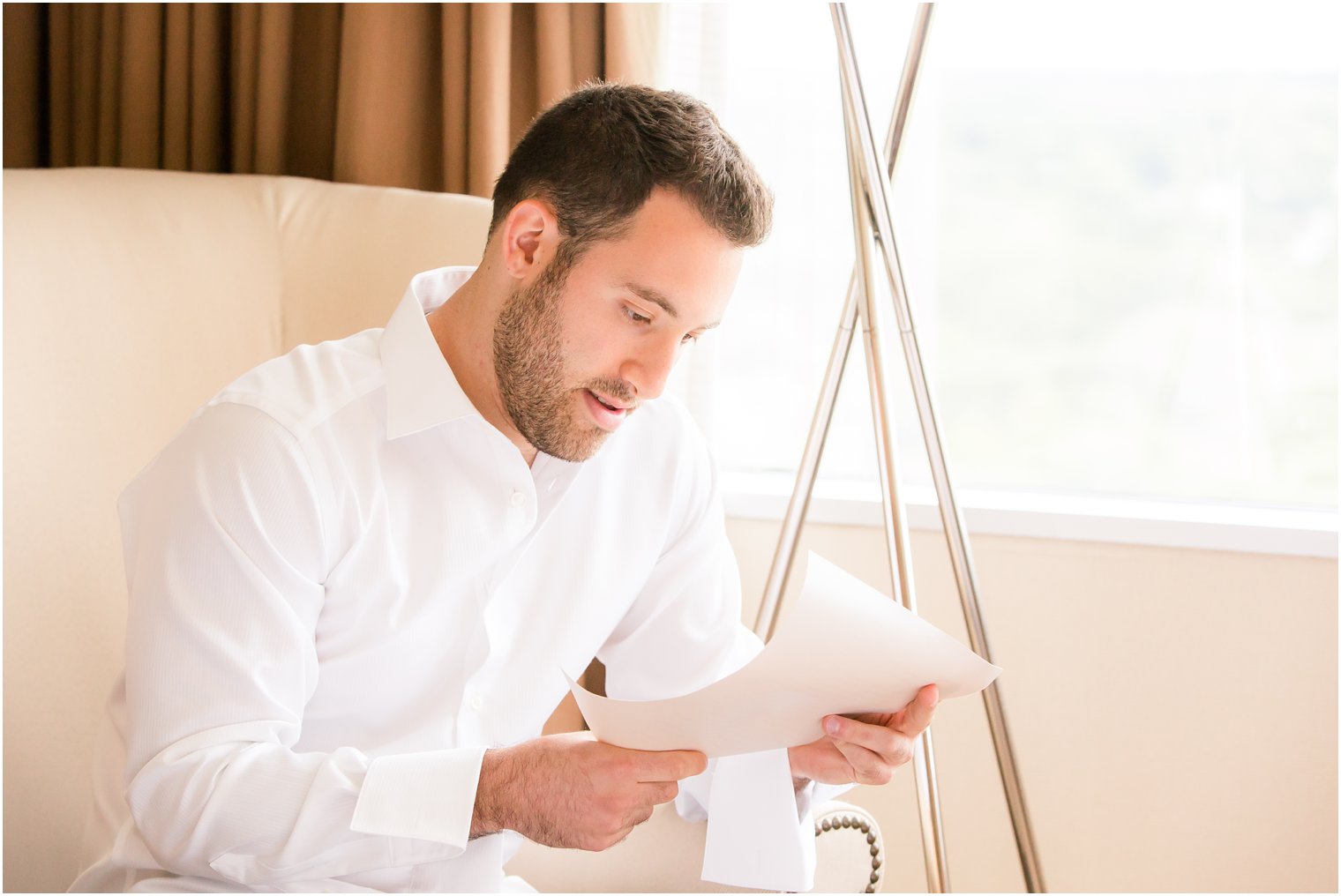 Groom reading letter from bride