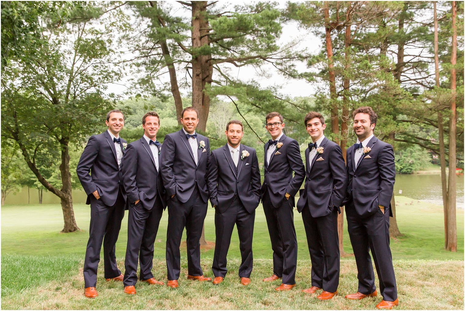 Groomsmen wearing navy | boutonnieres by Flowers by Joan